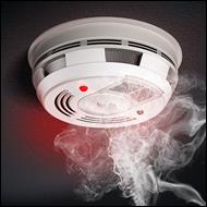 Smoke fumes rising into a smoke detector on a black background