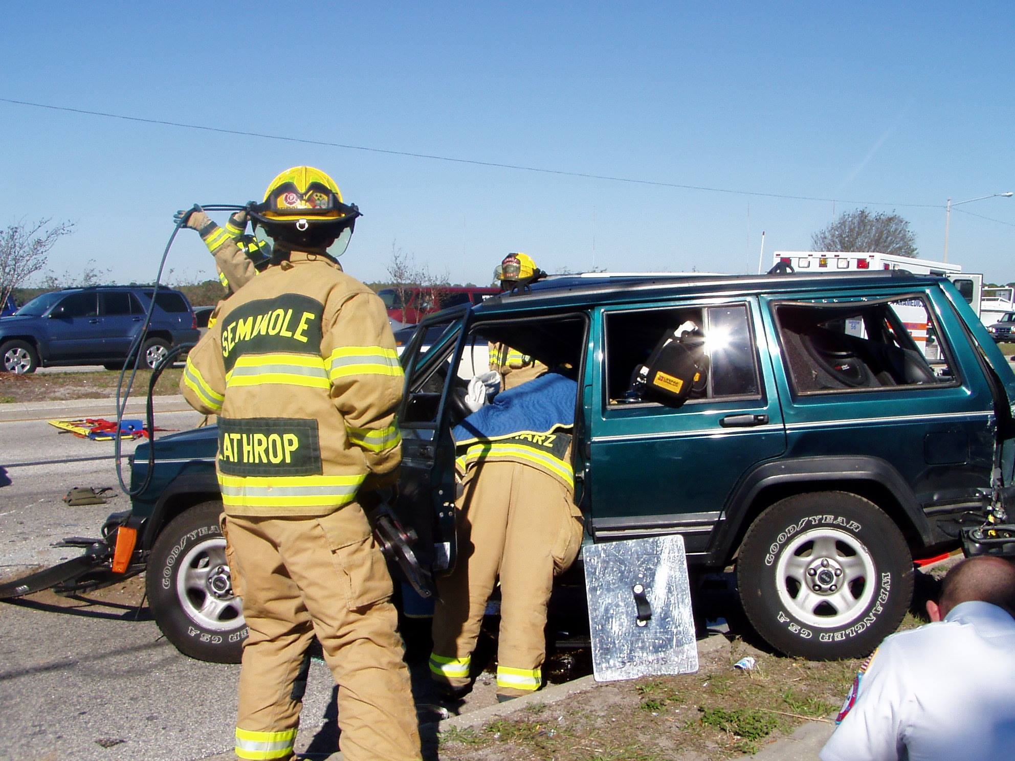 Extricating a crashed green Jeep Cherokee